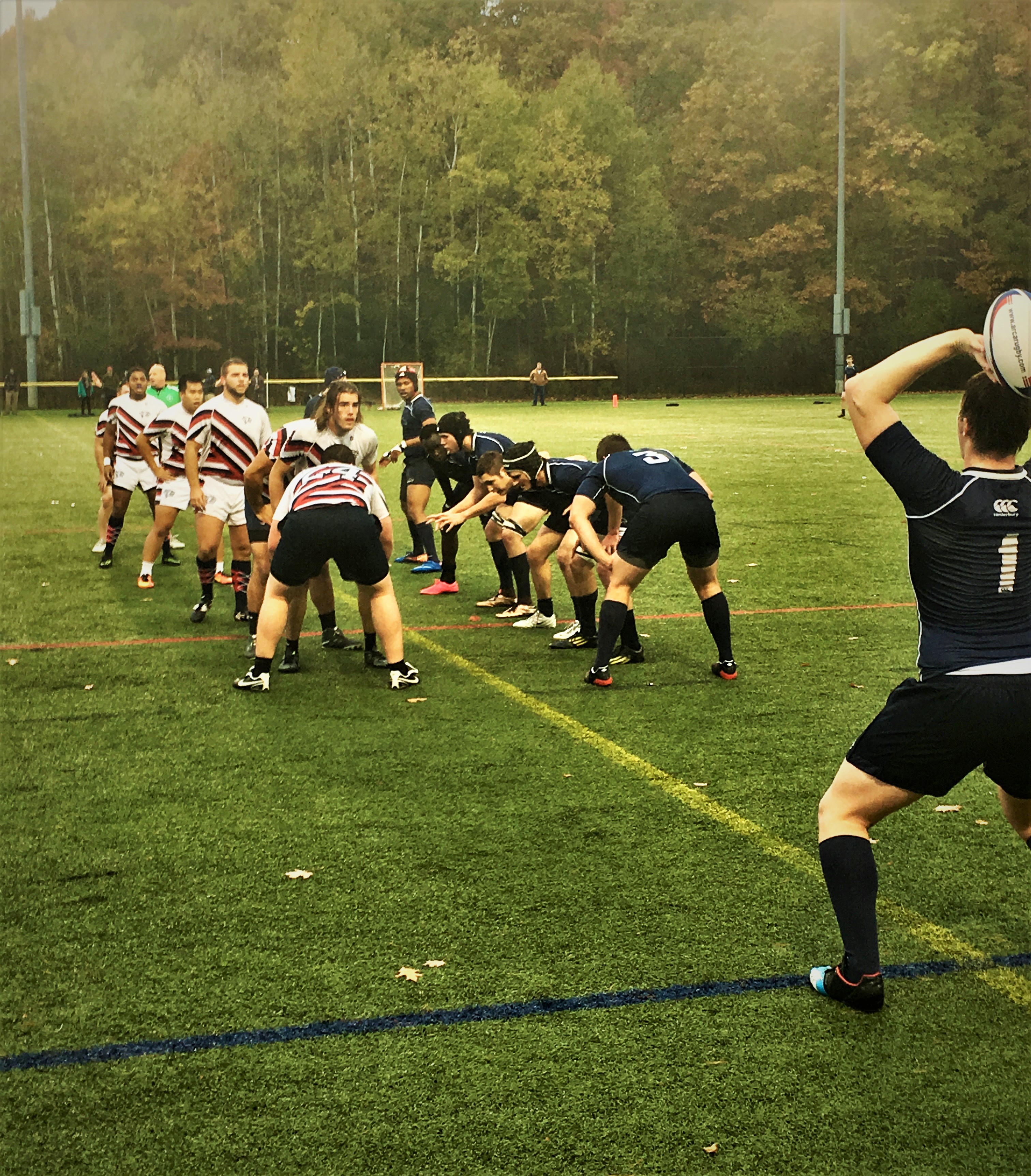 UNH mens rugby sets up for a play 