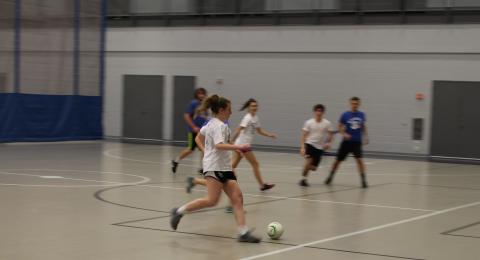 Students playing indoor soccer 