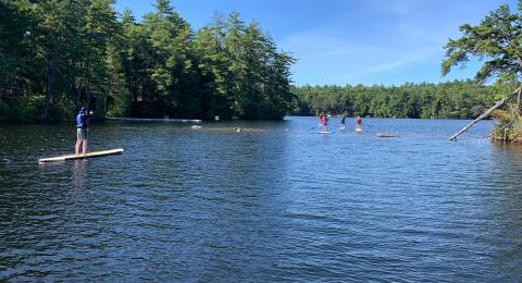 Wide shot of Mendums Pond with paddleboarders in distance