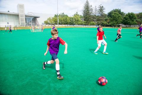 children playing soccer on UNH field
