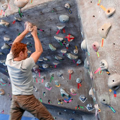 unh student on climbing wall