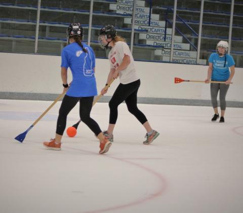 students playing broomball