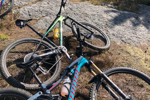 Two mountain bikes on top of a mountain