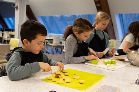 Kids slicing fruit 