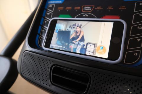 Smart Phone on an exercise bike with virtual group exercise video