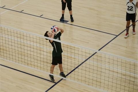 Young child playing volleyball.