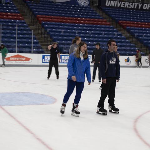Two skaters skating at the Whittemore Center 
